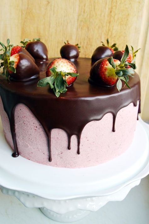 ina gartens rich dark cocoa cake is filled and frosted with fresh strawberry puree cooked flor buttercream and covered in a chocolate ganache and adorned with chocolate dipped strawberries Strawberry Cake With Chocolate, Chocolate Covered Strawberry Cake, Cake With Chocolate Ganache, Chocolate Covered Strawberry Recipe, Blackberry Syrup, Cocoa Cake, Covered Strawberry, Chocolate Covered Strawberry, Chocolate Dipped Strawberries