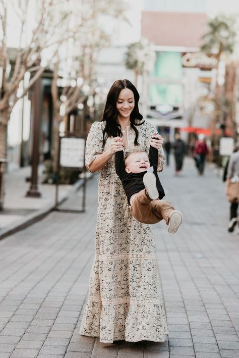 Cute Easter Dresses for Spring featured by top US fashion blog, Outfits & Outings: image of a woman wearing a maxi floral dress with her baby wearing a pink color block dress