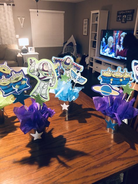 Buzz Lightyear party centerpieces Woody And Buzz Centerpieces, Buzz Lightyear Centerpieces Party Ideas, Buzzlight Year Party Ideas, Buzz Light Year Centerpieces, Diy 90th Birthday Decorations, Buzz Lightyear Centerpieces, Toy Story Table Centerpieces, Centerpieces For Birthday Party, Centerpieces For Birthday