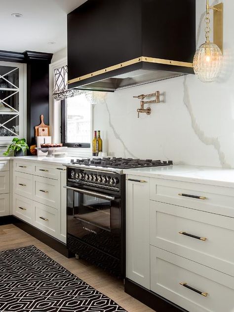 A black trellis runner sits in a black and white kitchen in front of a black Fisher and Paykel Stove placed between white shaker drawers donning black and gold pulls. Modern Fridge, Kitchen Goals, White Shaker Kitchen, White Wall Tiles, Glass Front Cabinets, Brown Kitchens, Kitchen Hoods, Gold Kitchen, Kitchen Views