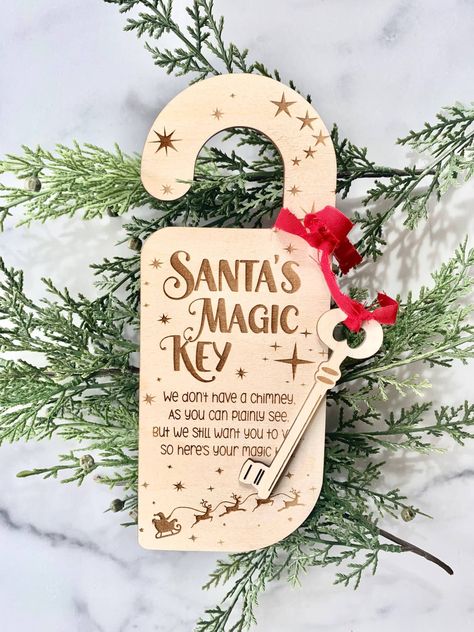 "Santa's Magic Key Door Hanger Ornament Don't have a Chimney for Santa? No worries! The Kids Will Have Fun Hanging our Magic Key Door Hanger up For Santa So He has a Key to get in and Leave Their Presents Under The Tree! Laser Engraved on 1/8\" Baltic Birch with Ribbon. * Measures approx 9\" long and key attached is approx 4\" long * Hanger and Key are cut from 1/8\" Baltic Birch * All products are made and shipped from our small business in Savannah, GA * Due to the handmade nature of our sign, Laser Engraved Christmas, Craft Fair Christmas Ideas, Small Business Christmas Ideas, Laser Cut Christmas Ideas, Laser Christmas Ideas, Christmas Lasercut, Santa Magic Key Door Hanger Svg, Santas Key Door Hanger, Santa Magic Key