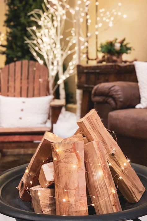 Twinkle lights + fire logs to create a centerpiece for an Apres Ski event Apres Ski Christmas Decor, Cabin Party Decorations, Apres Party Theme, Winterfest Ideas, Apres Ski Party Ideas, Apres Ski Decorations, Cozy Cabin Theme Party, Ski Theme Birthday Party, 80s Ski Party Decorations