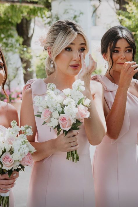 Bridesmaids wearing pale pink one shoulder dresses with bow at shoulder for an Italian outdoor wedding Classy Bridesmaid Dresses Pink, Pink Bridesmaid Dresses With Bow, Bridesmaid Dresses With Bows On Shoulder, Bow Strap Bridesmaid Dress, Bridesmaid Hairstyles With Off Shoulder Dress, Peony Pink Bridesmaid Dresses, Pink Bow Wedding, Pink Bridesmaid Dress With Bow, Soft Pink Bridesmaid Dresses