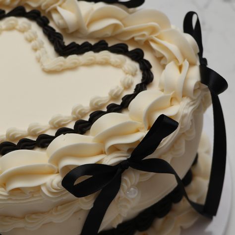 🤍🖤 - Cake Details - Size: Standard 7” (two layers) Add-ons: Long black bows (not edible) #emmacakesseattle #emmacakes #seattle #seattlecakes #heartcake #vintagecakes Black Vintage Heart Cake, Two Tier Heart Cake, Tier Heart Cake, Heart Shaped Wedding Cakes, Vintage Heart Cake, Happily Ever After Party, Ever After Party, Heart Wedding Cakes, Heart Cakes