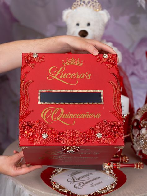 Introducing a stunning red Quinceañera Money Card Box, the perfect centerpiece for your celebration!This Quince Money Box is elegantly designed in a lustrous red color, adding a touch of opulence to your event. The box is crafted with high-quality materials and can be personalized with the name and date of the Quinceañera, making it a cherished keepsake for years to come. Order yours today and make your Quinceañera a truly unforgettable experience!The size of Money Card Box is 10 x 10 inchesAll Red And Gold Charro Quinceanera Theme, Quince Red Theme, Quince Money Box Ideas, Red Quince Centerpieces, Red Centerpieces For Quinceanera, Red Quinceanera Invitations, Red Quinceanera Ideas Decor, Red Quince Decorations, Red Gold Quinceanera