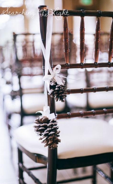 WEDDING DECOR | NgLp Designs shares whimsical winter wedding décor — style it with winter whites and natural pine cone décor | organic, nature, wedding decor, wedding decorations, chair decor, pine cone, white ribbon  /// #winterwedding #weddingdecor #pinecones Wedding Isles Decoration Winter, Winter Wedding Pinecones, Pinecone Wedding Decorations, Pine Cone Wedding, Wedding Ceremony Chairs, Fun Wedding Decor, Estes Park Wedding, Elegant Winter Wedding, Ceremony Chairs