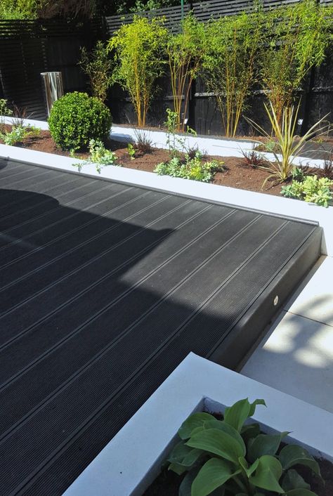 Browse images of black modern Garden designs: Composite Decking Platform. Find the best photos for ideas & inspiration to create your perfect home. Black Decking Garden, Modern Decking Ideas, Black Composite Decking, Black Patio Floor, Black Decking Ideas, Garden Floor Ideas, Black Decking, Seashell House, Garden Flooring