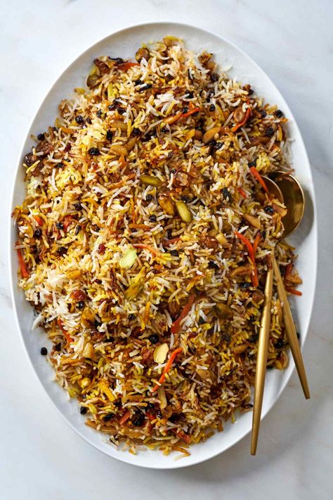 Traditionally served at weddings, this delicious jeweled rice brings sweetness to new couples. This regal rice is filled with dried fruit, nuts, and candied orange peel. You aren't ready for how gorgeous and tasty this is! Fruit And Meat Recipes, Red Rice Recipes, Persian Jeweled Rice, Adas Polo, Friend Rice, Zereshk Polo, Persian Food Iranian Cuisine, Jeweled Rice, Dill Rice