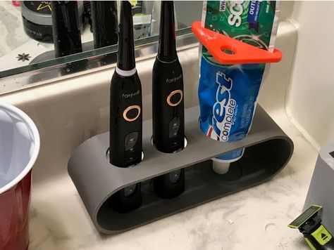 This is just a simple electric toothbrush and toothpaste holder. Recently the wife and I switched to electric toothbrushes, and I needed a stand to keep the 6 inches of bathroom counter space my wife lets me have at least somewhat organized. Should fit most electric toothbrushes and a standard tube of toothpaste Electric Toothbrush Holder Ideas, Ceramic Electric Toothbrush Holder, Ceramic Tooth Brush Holder, 3d Printed Toothbrush Holder, Wooden Toothbrush, Ceramic Toothbrush Holder, Electric Toothbrush Holder, Toothbrush Organization, Toothbrush Holder Wall