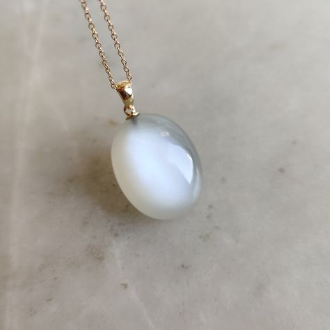 This stunning pendant is set in 14K Solid Yellow Gold with Natural White Moonstone with utmost precision. It is an unique gemstone pendant for nearly every occasion and is completely hassle-free jewelry. ITEM DETAILS * Gem: White Moonstone * Gem Size: 18X23mm * Gem Shape: Oval * Gem Weight: 34.12 carats * Gold Purity: 14KT  * Gold Weight: 0.42 gram * Total Weight of the Pendant: 7.25 gram The Gold purity is guaranteed and it comes with authentic 14KT gold hallmark. Since my items are handmade, they are absolutely nickel and lead free. Natural White Moonstones cabochon with drill setting and gold bail are studded on it with utmost precision.  CUSTOMIZATION * Gemstone customization is available and it can be substituted with a gem of your choice. Kindly message me for the same. PACKAGING * T Mystical White Moonstone Necklace, Moonstone Amulet Necklace With Gemstone, White Moonstone Oval Pendant, Moonstone Amulet Pendant Necklace, Moonstone Pendant Amulet Jewelry, Swan Jewelry, Ethereal Jewelry, Drill Set, Handmade Jewelry Box