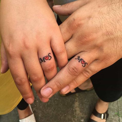 Top 70+ Best Matching Tattoos Ideas - [2021 Inspiration Guide] Names On Finger Tattoo, Matching Ring Tattoos Couples, Ring Finger Tattoo For Women Initials, Name On Ring Finger Tattoo, Wedding Ring Tattoo Ideas Couple, Marriage Tattoos Ring Finger, Wedding Ring Tattoos For Couples, Heart Ring Tattoo, Tattoo Heartbeat