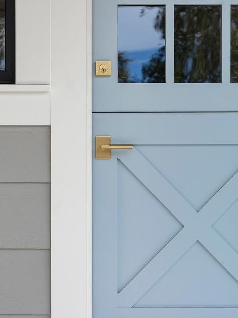 A blue dutch front door accented with brass knobs is fitted with glass panels. Living Space Ideas, Garage Door Types, Blue Front Door, Front Door Paint Colors, Blue Shutters, Stucco Homes, Door Paint Colors, Painted Front Doors, Dutch Door