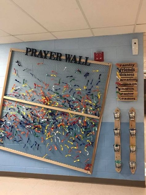 Use a space on your walls to put up a prayer wall like this. Using fabric scraps, tissue paper, or anything lightweight and flexible and give each color a topic of prayer request. Encourage the youth to go each service and pray over some of the colors, maybe even recruit a few who want a way to serve to go and pray over them and help reset the board every couple weeks. High School Ministry Room, Kids Prayer Wall, Verse Of The Week Board Diy, Prayer Wall For Kids, Youth Art Projects, Youth Decorations Church, Answered Prayers Board, Church Youth Group Room Design, Christian Prayer Room Design Ideas