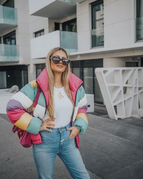 rainbow puffer jacket, celine alphabet necklace, pink balenciaga city bag, komono stella sunglasses and closed pedal pusher mom jeans. Pink Balenciaga, Alphabet Necklace, Pedal Pushers, White Converse, City Bag, Basic Shirts, Balenciaga City Bag, Puffer Jacket, Alexander Wang