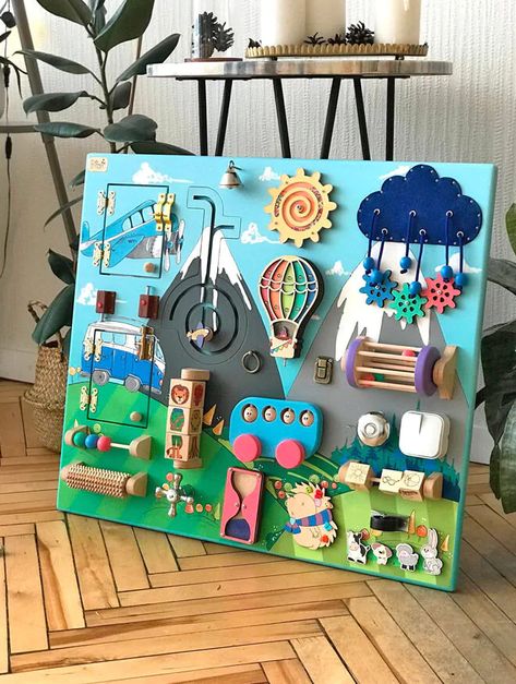 21 toddler busy boards for fine-tuning motor skills | Mum's Grapevine Sensory Boards For Preschoolers, Wall Mounted Busy Board, Handmade Busy Board, Activity Wall For Toddlers, Diy Sensory Boards, Baby Zintuiglijk, Fidget Board, Perlengkapan Bayi Diy, Baby Activity Board