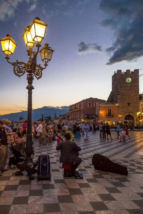 Taormina is a hilltop town on the east coast of Sicily. It sits near Mount Etna, an active volcano with trails leading to the summit. The town is known for the Teatro Antico di Taormina, an ancient Greco-­Roman theater still used today. Near the theater, cliffs drop to the sea forming coves with sandy beaches. A narrow stretch of sand connects to Isola Bella, a tiny island and nature reserve. Italian Trip, Sicily Travel, Italy Destinations, Taormina Sicily, Best Of Italy, Living In Italy, Italy Tours, Italy Aesthetic, Sicily Italy