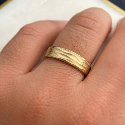 Details: 10k or 14k gold, sterling silver Horizontal wave finish 6mm wide, 1.2mm thick Polished edges and interior Gentle comfort fit interior edge Available in quarter sizes by request For platinum, or 18k gold or higher, karat please email us for a quote Style: Our Unique Gold Band Ring Inspired by Serene Beaches Imagine capturing the essence of summer and the tranquility of a beach within a ring – our Gold band ring does just that. Inspired by the gentle waves etched in the sand and the peace Gold Wave Ring, Wave Ring, Montana Sapphire, Gold Band Ring, Enamel Ring, Salt And Pepper Diamond, Wedding Board, Emerald Ring, Gold Band