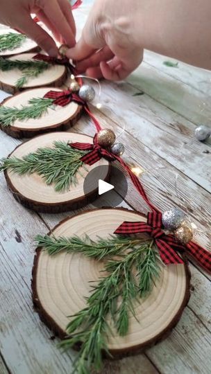 DIY Christmas Wood Slice Garland | Here's the video for the wood slice Christmas garland using my own dried pressed juniper ✨️🎄I hope y'all enjoy the video!   Also, thank you so much for... | By Love Crafted Decor | Hey y'all here's how I made the Christmas Wood Slice Garland so I'm using real pressed juniper that I got off of my own little juniper bush in my yard I got these wood slices off of Amazon and I'm just gluing the pieces of pressed juniper to the wood slices and then I'm feeding through a little piece of twine to make them into a little hanger and you could honestly use all these same steps to make these into ornaments instead if you don't want to make this into garland and then just add a little color to them I'm using this buffalo check mini bows and y'all I'm still working o Ornaments Using Wood Slices, Diy Wood Slice Ornaments For Kids, Christmas Decorations Wood Slices, Christmas Wooden Garland, Buffalo Check Christmas Ornaments Diy, Wood Slice Tree, Ornaments Out Of Wood Slices, Wood Slices Wreath, Things To Make With Wood Slices