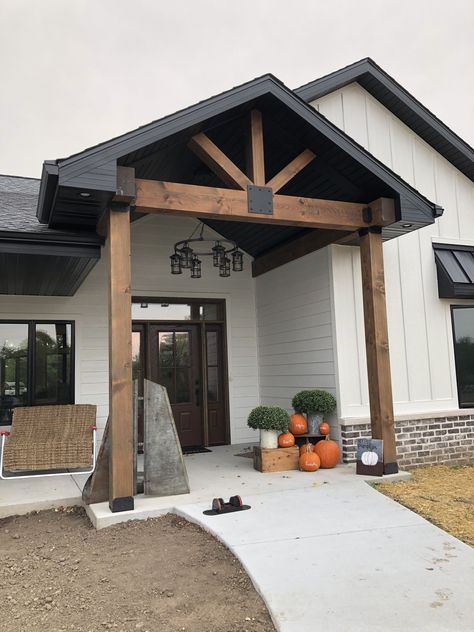 Covered Entryway Exterior Modern, Exterior Beams Front Porches, Porch Gables On House Exterior, Wood Gables On House Exterior, Black White And Cedar Exterior, Dark House Exterior With Wood, Front Porch Gable Ideas, Porch Gable Ideas, Front Gable Porch Entrance