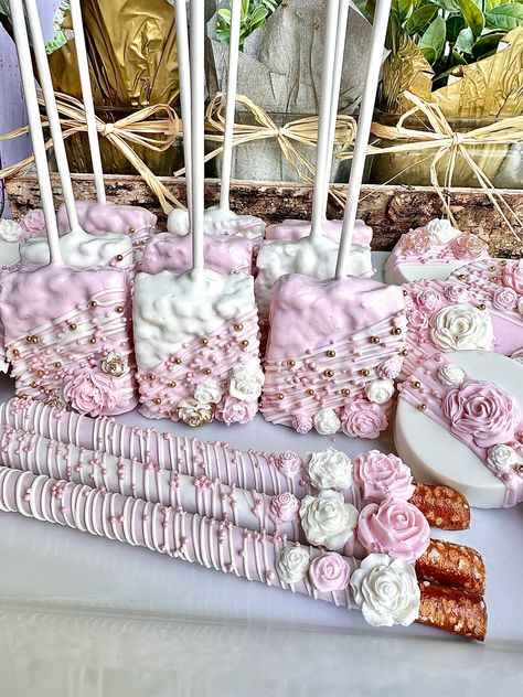 This gourmet White and pink colored Chocolate treats party bundle contains the below listed gorgeous confections. Each treat will be dipped in pink and white colored chocolate and then dazzled with a drizzle, nonpareils and chocolate flowers. If you need a larger quantity please message me for a custom order.  12 Pretzel Rods  12 Chocolate Covered Oreos  12 Rice Krispie treats  Each treat will be individually wrapped in a crystal clear cellophane sleeve and tied with color coordinating ribbons or ribbon color of your choice.  Delightful Chocolates cannot be held responsible for melted or broken chocolate once the package has left our possession. We also cannot be held responsible for how the postal service treats or handles our packages. We take great pride in insulating our boxes and pack Pink And Gold Dessert Table, Pink And White Treats, Pink Chocolate Covered Treats, Dipped Treats, Pink And White Birthday, Pink Treat Table, Pink And White Rice Krispie Treats, Rice Krispie Treats Pink, Sweet Treat