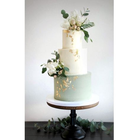 Sage green wedding cake. Buttercream finish with fresh flowers and gold leaf. Wedding Cakes Olive Green, Sage Green And Gold Wedding Cake, Wedding Cake Olive Green, Wedding Cake Sage Green, Sage Green Wedding Cake, Wedding Cake Olive, Cake With White Flowers, Wedding Cake Gold Leaf, Wedding Sage Green