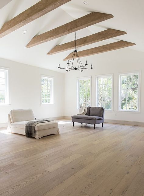 Expansive modern living room with vaulted ceiling and exposed beams. The flooring is wide white oak Beams Living Room, Vaulted Ceiling Living Room, Exposed Beams, Wood Beams, Ceiling Beams, Wood Flooring, House Flooring, Ceiling Design, White Walls