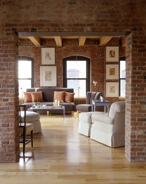 a chic living room with red brick walls highlighted with white grout and elegant upholstered furniture Red Brick Interior Design, Brick Wall Interior Living Room, Red Brick Interior, Living Room With Brick Wall, Brick Interior Design, Brick Wall Living Room, Brick Interior Wall, Modern Rustic Living Room, Rustic Apartment