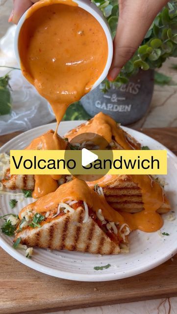 Neeti Jain on Instagram: "Schezwan cheese’ volcano sandwich 🥪🤤  Preparation time:40min Serve: 3 sandwiches   Ingredients used for cheesy schezwan sauce: •1tbsp butter •1tbsp refined flour  •1/2cup milk •1to2tbsp mayo •1/4th cup /2cheese cube grated cheese •2to3 tbsp schezwan sauce   *You can add salt if required   Ingredients used for filling: •1cup finely chopped cabbage  •1cup finely chopped capsicum  •1cup finely chopped onions •1tbsp green chilli •1/2tsp salt  •1/4th cup cheese/ 2cheese cube •Fresh coriander  •3to4tbsp schezwan sauce   Ingredients used: •Bread •Butter  •Schezwan sauce  •Cheese  #dosa #streetdosa #streetfood #pizzadosa #dosalovers #masaladosa #borivalifamousfood #foodporn #foodblogger #foodie #streetfoodindia #streetfoodlover #mumbaifood #mumbaisteetfood #borivali #bo Jain Bread Recipe, Volcano Sauce Recipe, Indian Sandwich Recipes, Cabbage Sandwich, Cheese Dosa, Sandwich Recipes Indian, Mayo Sandwich, Schezwan Sauce, Cheese Sandwich Recipes