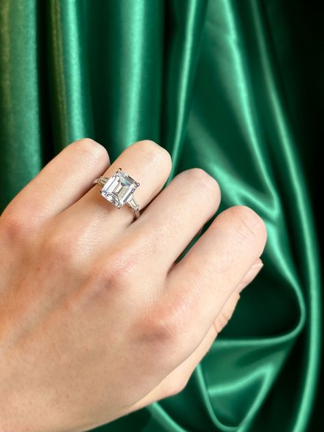 A creation that marries the rich depth of an emerald-cut lab-grown diamond, with the sleek sophistication of 18K white gold.⁠ ⁠ A piece that is both a statement and a staple.⁠ ⁠ RING DETAILS:⁠ Bespoke Emerald-Cut Diamond with Taper Baguettes Trilogy Ring⁠ Carat weight: 5.00ct Emerald-Cut, 0.30ct Taper Baguettes⁠ Colour: D/E⁠ Clarity: VVS1⁠ Metal: 18K White Gold⁠ ⁠ #labgrowndiamond #Uniqueengagementring #engagementringinspiration #engagementringgoals #ethicalluxury #sustainableluxury #MarliiLab Trilogy Engagement Ring, Engagement Ring Inspiration, Traditional Engagement Rings, Trilogy Ring, Emerald Cut Diamonds, Custom Engagement Ring, Unique Engagement Rings, Vintage Engagement Rings, Emerald Cut