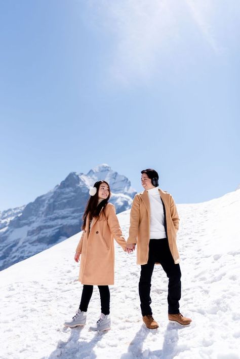 A beautiful spring engagement photoshoot in Grindelwald, Switzerland Switzerland Photoshoot Couple, Switzerland Photography Couple, Switzerland Dress Ideas, Couple Poses In Switzerland, Mt Titlis Switzerland Outfit, Swiss Photoshoot, Snowfall Photoshoot, Switzerland Outfit Ideas, Kashmir Photoshoot