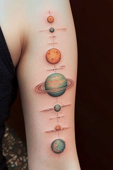 A colorful planet arm tattoo for women, featuring planets in various hues arranged along the forearm in a cosmic theme. Color Planet Tattoo, Solar System Tattoo Color, Saturn Return Tattoo, Unique Tattoos For Women Arm, Venus Planet Tattoo, Earth Element Tattoo, Earth Tattoo Ideas, Space Tattoo Designs, Cool Space Tattoos