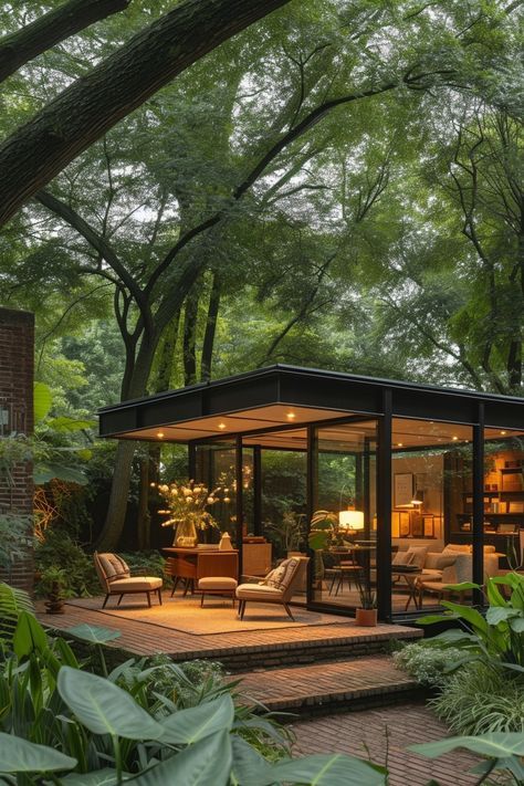 A stylish office set in a garden pavilion structure, with mid-century modern furniture surrounded by lush landscaping, offering an inspiring and refreshing environment for creative pursuits. Garden House Architecture, Garden Studio Ideas, Office Design Exterior, Mid Century Modern Cabin, Garden Gazebo Ideas, Pavilion Structure, Taman Ujung, Mid Century Modern Backyard, Garden Office Ideas