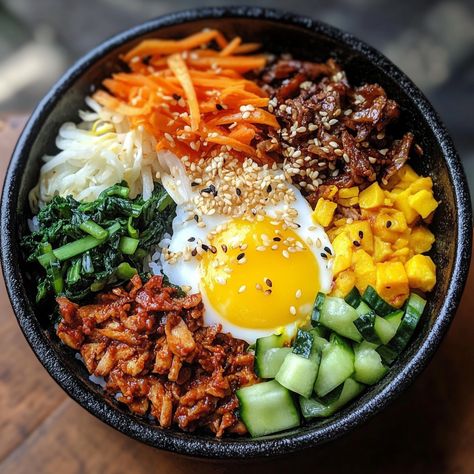 Bibimbap originated from Korean royal cuisine but quickly became a beloved dish for the masses. Traditionally, it was a way to use leftover vegetables and rice, with everything mixed together for a colorful, flavorful meal. Its vibrant presentation symbolizes harmony and balance, two important principles in Korean culture.

#Bibimbap #KoreanFood #HealthyMeals #Gochujang #AsianCuisine #RiceBow Korean Mixed Rice, Bimbimbop Bowl, Bibimbap Aesthetic, Asian Food Healthy, Chicken Bibimbap, Traditional Korean Food, Uni Meals, Korean Bowl, Leftover Vegetables