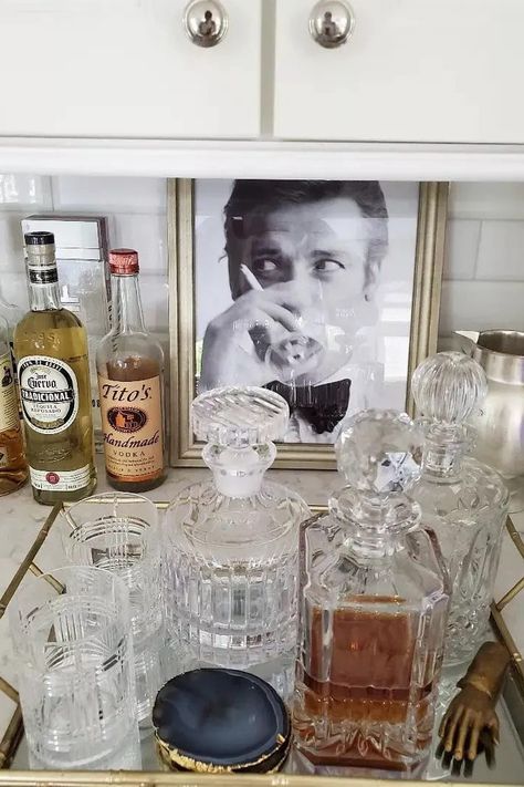 While we've seen some pretty extraordinary at-home bar setups that span an entire countertop, the good news is that you don't need much extra space on hand in order to create a bar station of your own. #SmallCocktailStation #BarCart #HomeBar #BarCartIdeas #TheSpruce Countertop Bar Tray, Tabletop Bar Ideas, Home Liquor Bar, Liquor Station Ideas, Home Cocktail Station, Home Bar Styling Ideas, Bar On Countertop, Vintage Bar Accessories, How To Style A Home Bar