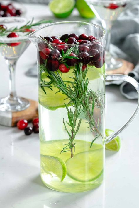 This winter cosmo inspired cocktail is great for holiday parties and serving a crowd. It's made with vodka, cointreau, rosemary, limes and cranberries. Batch Winter White Cosmo, White Cosmopolitan Recipe, Winter Cosmo, Winter White Cosmo, White Cosmopolitan, Winter Vodka Cocktails, Lemonade Margarita, Good Alcohol, Party Food Ideas Appetizers