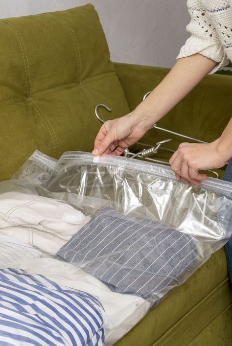 woman packing her seasonal clothes and using vacuum space bag to stay organized Chalkboard Vinyl, Kids Toy Store, Space Bags, Organization Station, Vacuum Bag, Clean Space, Door Organizer, Old Computers, Organizing Tips