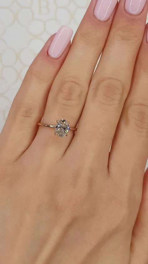 This elegant ring has a 1.02 carat oval cut main diamond graded at "G" in color and "VS2" clarity enhanced, (Excellent Cut, Polish and Symmetry) and is set in a classy solitaire setting with a hidden halo underneath for that extra brilliance in 14k rose gold. Comes with a Gemological certificate, appraisal and our lifetime warranty as well. 1.2 Carat Oval Diamond, Classy Ring, Cushion Cut Solitaire, Dream Rings, Tiny Wedding, Oval Diamond Engagement, Beautiful Diamond Rings, Wedding 2025, Solitaire Setting