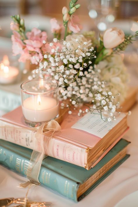 Celebrate your love of literature with book centerpieces that bring a personal touch to your wedding. Click for inspiration. Little Details For Wedding, Bridgerton Centerpiece, Princess Wedding Reception, Book Baby Shower Ideas, Bridgerton Prom, Simple Elegant Wedding Ideas, Vintage Book Centerpiece, Wedding Diy Centerpieces, Book Wedding Centerpieces