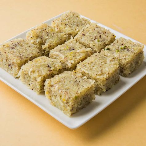 Coconut burfi is served as a sweet in Indian Thali. It is popular and widely consumed in South India. simple and tasty indian fudge recipe prepared mainly with grated coconut, sugar and milk. it is a common indian dessert recipe prepared during diwali, holi, raksha bandan & navaratri. it can also be made with condensed milk and desiccated coconut, but this recipe follows the traditional recipe. Coconut burfi is a delicious south Indian Sweet recipe made with coconut, sugar, milk and cardamom Coconut Barfi Recipe, Barfi Recipe, Coconut Burfi, Burfi Recipe, Gulab Jamun, Sweet Meat, Indian Dessert Recipes, Indian Sweet, Indian Desserts