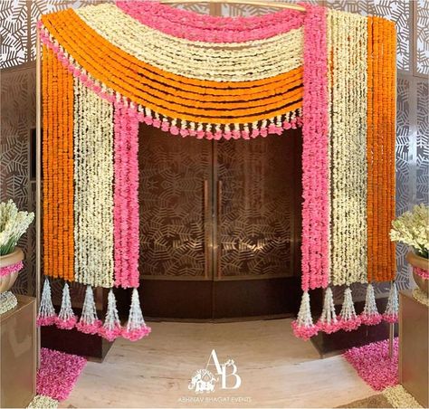 Vibrant Floral setup for an intimate Roka ceremony Decor @abhinavbhagatevents Follow www.decorsutrablog.com for Ideas about Indian Wedding Decor Email your original pictures to @decorsutrablog@gmail.com to get featured. #wedmegood #weddingsutra #shaadisaga #shaadimagic #weddingz #WeddingInspiration #decoration #weddinginspo #instawedding #weddingflowers #haldiceremony #weddingreception #traditionalwedding #engagementdecor #weddingdetails #indianweddings #shaadi #dreamwedding #northindianwedd Wedding Gate Decor, Entrance Decor Ideas, Intimate Home Wedding, Floral Decor Ideas, Hanging Floral Decor, Roka Ceremony, Wedding Gate, Indian Wedding Flowers, Home Flower Decor