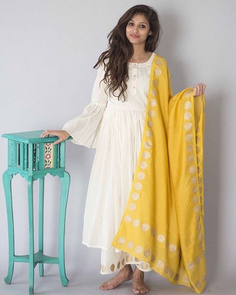 Colors which never you down, its a lifestyle. Fabric which make you feel confident and stylish. Grab the ivory suit set with mustard dupatta  Price - DM Sizes - xxxs-10xl #ordernow  Fabric - cotton . . Sale is going on. .  Shop now . . . #newcollection . . #cotton #jaipurshopping #sidharthshukla @shehnaazgill @colorstv @endemolshineind @realsidharthshukla #manishmalhotra  #sidnaaz #fashionblogger #sidnaaz #arab #traditionaltattoo #libas #vihaarna #handlettering #pinkvilla #asianfashion #sidharth White Cotton Anarkali, Yellow Dupatta, डिजाइनर कपड़े, Yellow Kurta, Cotton Anarkali, Long Cape, Indian Designer Suits, Salwar Kamiz, Anarkali Suit