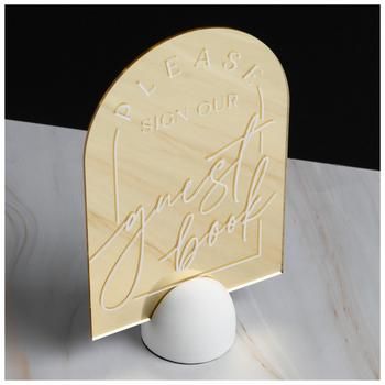 Dimensions: 9.25" H x 5.81" W x 2.88" D Material: Plastic & Resin Shape: Arch Color: Gold & White Orientation: Vertical Quantity: 1 Your wedding is a day to celebrate your love with the people you care about most! Guest Book Mirror Sign is a gold-colored, arched mirror that has the phrase "Please Sign Our Guest Book" on it in white script. It has a white, semi-sphere base with a black, velvety bottom to keep it from falling over. Put out this mirror sign to ensure your guest book is filled with Please Sign Our Guest Book, Mirror Wedding Signs, Wedding Mirror, Arched Mirror, Mirror Sign, Favors Sign, Plastic Resin, Book Ideas, Gold Mirror