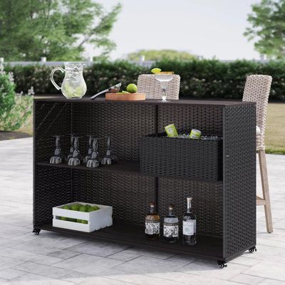 Create a relaxing getaway for your next backyard get-together with this outdoor bar set. It's crafted with a resin wicker-wrapped aluminum frame for weather resistance and year-round use, with sleek, modern lines. The bar cart stands on convenient caster wheels so you can easily move it around your patio, and it comes with a wicker basket that can hold bottles of wine and glasses so you're always ready to entertain. Assembly is required, so call up some friends to help you put it together - then Bar En Plein Air, Side Basket, Terrace Bar, Villa Terrace, Wood Bar Cart, Metal Bar Cart, Drink Storage, Outdoor Bar Sets, Rolling Kitchen Island