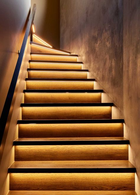 In a close-up look at these modern stairs, you can see the hidden LED lighting strips that are located underneath the tread, and highlight the stair riser. Stair Tread Lighting, Under Stair Lighting, Closed Staircase Ideas, Home Staircase Design, Closed Staircase, Stair Treads And Risers, Mansfield House, Feature Staircase, Stairs Floating