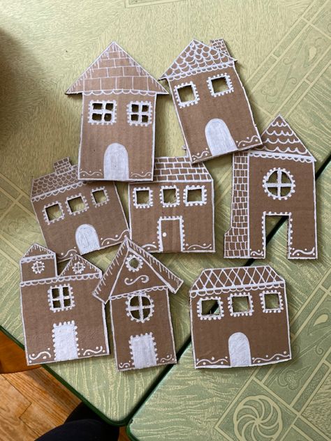 Homemade cardboard gingerbread houses that will be made into a garland! Cardboard Gingerbread House Garland Diy, Cardboard Gingerbread Garland, Gingerbread Houses Cardboard, Diy Cardboard Christmas Crafts, Cardboard Gingerbread House Garland, Gingerbread Cardboard House, Cardboard Gingerbread House Diy, Gingerbread House Cardboard, Cardboard Gingerbread Houses