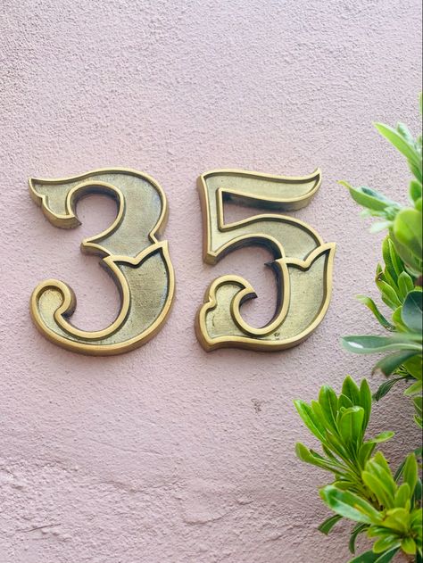 Number 35 brass house numbers on exterior house wall. Victorian Typography, Brass House Numbers, Front Door Numbers, Unique Front Doors, Address Signs, Brass Door Knocker, Front Door Entrance, Door Numbers, House Number Sign