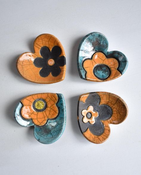 Some bright colours on a wet day in Fife. I’ve been pressing flower shapes into clay quite a bit recently. They’ve come out well on these little heart shaped trinket dishes. I think I need flowers in my life. It would be nice for spring to make an appearance, now please! 🌼☀️ . . . #springinscotland #scottishspring #trinketdishes #trinketdish #hearts #heartshapedgifts #heartart #rakufired #raku #handmadeinfife #scottishpottery #scottishpotters #daisy #artwithflowers #trinkets Galentines Ideas, Clay Trinkets, Flower Trinket Dish, Pottery Ring Dish, Pottery Ring, Flower Shapes, Pottery Crafts, Bright Colours, Heart Art