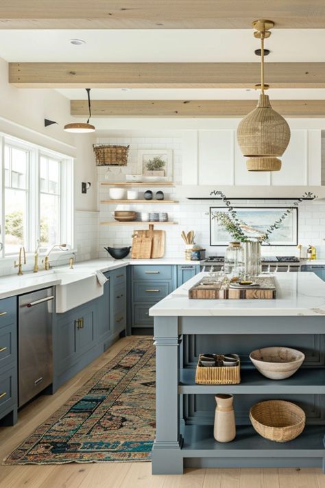 Step into this beautifully designed coastal farmhouse kitchen, where functionality meets the serene vibes of the seaside. The space features a generous island, perfect for gatherings and meal preps, paired with soothing color cabinets that evoke the tranquility of the ocean. Overhead, natural woven pendant lights cast a warm glow, complementing the open shelving that displays curated decor. The rustic runner adds a splash of color, seamlessly blending with the polished wooden accents. Kitchen Cabinets Island Different Color, Woven Pendants Over Island, Kitchen Coastal Farmhouse, Kitchens With Natural Light, Add Island To Kitchen, Beach Cabinets Kitchen, Kitchen Design Coastal Style, Earthy Blue Kitchen, Coastal Cozy Kitchen