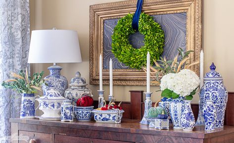 Join your favorite bloggers as we share our fall mantel decor, seasonal tablescapes and porches, as well as autumn-inspired wreaths and crafts. You'll be inspired to decorate your own home for the season. This cozy keeping room features a stone fireplace with a TV cabinet above it decorated with blue and white chinoiserie porcelain, pumpkins and copper accents, as well as a touch of mercury glass. Blue And White Mantle Decor, Hamptons Winter, Fireplace Mantels Decor, Wreath On Mirror, Decorating With Blue And White, Decorating With Blue And White Porcelain, Chinoiserie Porcelain, Blue And Green Living Room, Fall Mantel Decor