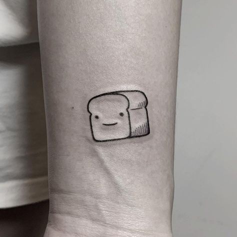 A super cute Bread Pitt tattoo inked on a wrist by @hellotako Bread Tattoo, Lil Tattoo, Lil Tattoos, Culinary Tattoos, How To Tattoo, Small Words Tattoo, Dbz Tattoo, Cute Bread, Unique Tattoos For Men